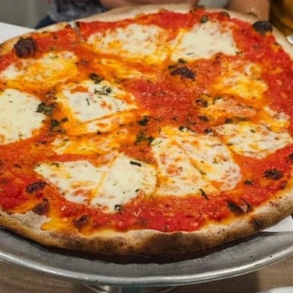 Marco Pizzeria's classic Margherita pizza with vibrant red sauce and melted white mozzarella cheese.