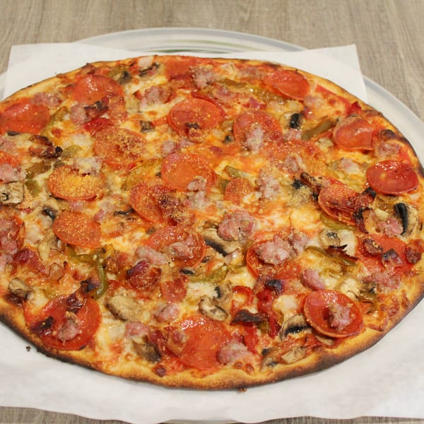 A whole Marco Pizzeria pizza, topped with pepperoni, sausage, mushrooms, and green peppers.